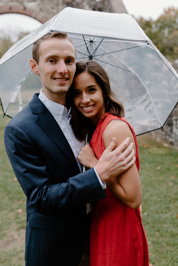 man and woman under umbrella smiling