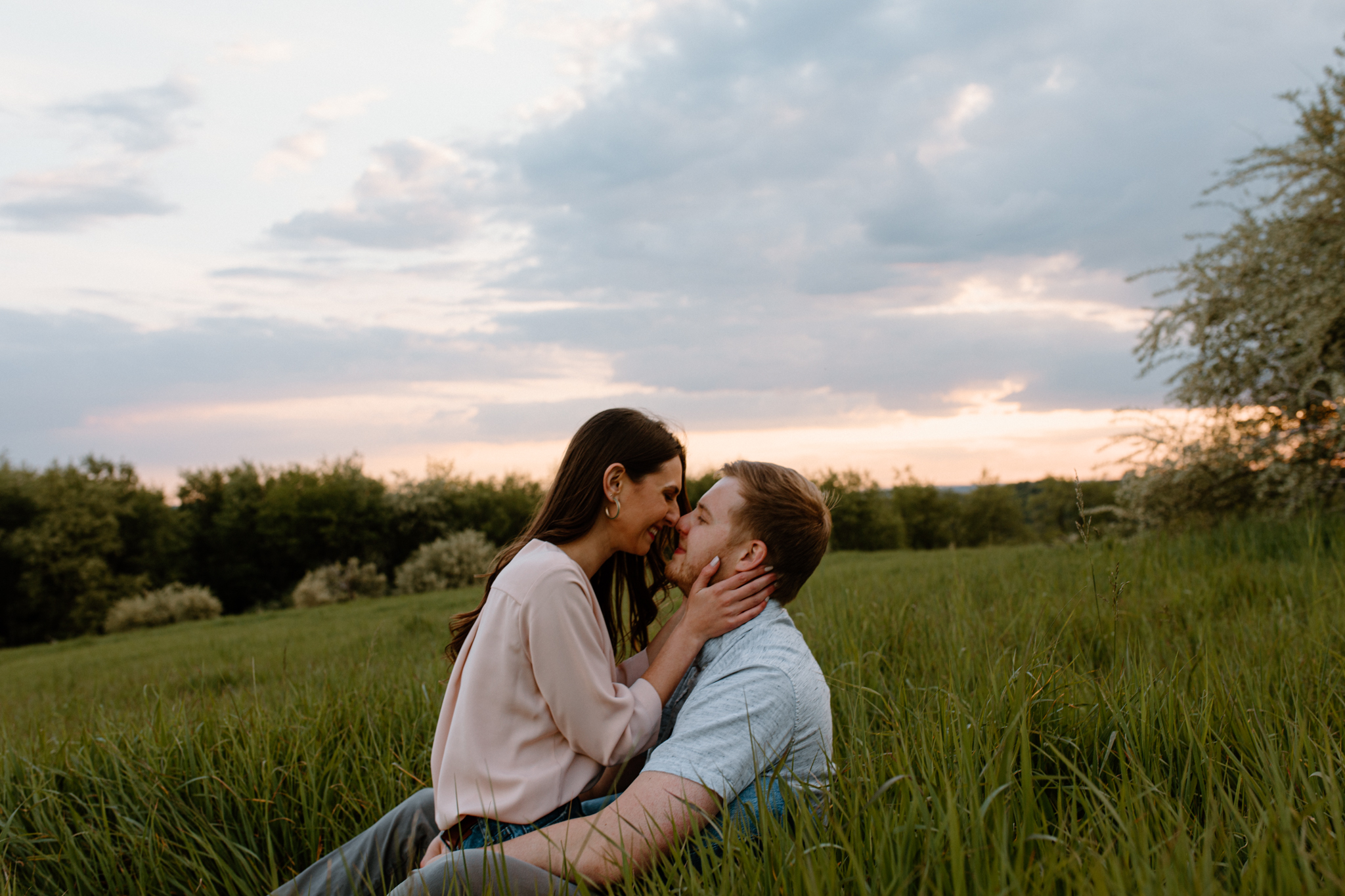 couple sitting in a field facing each other